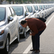 Inspecting the cars for sale at the Beijing Electric Vehicle Company in 2012.